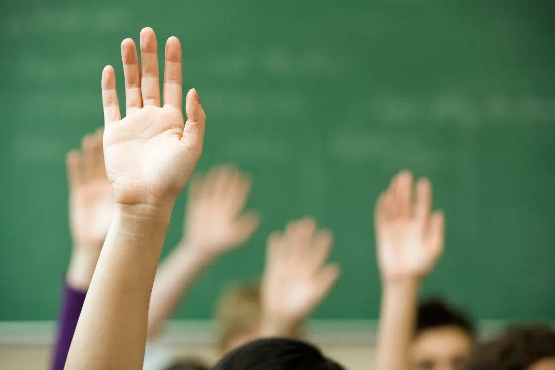 hands raised in classroom